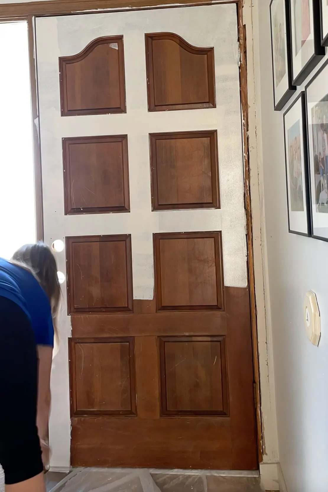 Priming a front door to prepare it for paint.